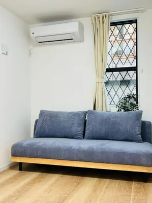 a blue couch in a room with a window at Lulu House 3BDR Room! Near Skytree in Tokyo