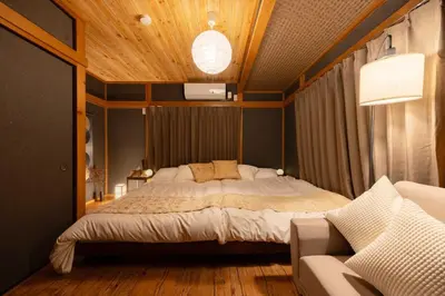 a bedroom with a large bed and a couch at Y's Hotel in Tokyo
