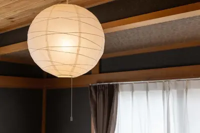 a paper lantern hanging from a ceiling with a window at Y's Hotel in Tokyo