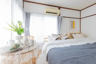 a bedroom with two beds and a table with a plate on it at Tokyo Ikebukuro House in Tokyo