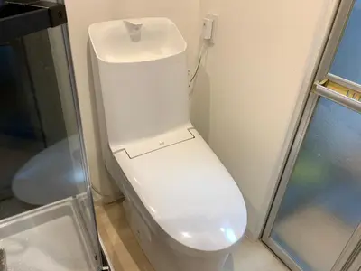a white toilet in a bathroom with a glass door at Tokyo Ikebukuro House in Tokyo