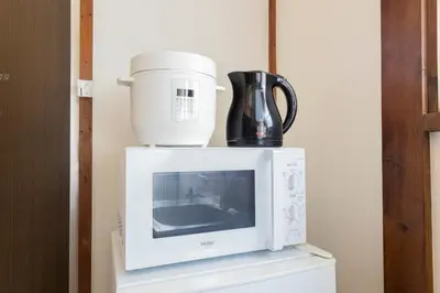 a coffee maker and a blender sitting on top of a microwave at Tokyo Ikebukuro House in Tokyo