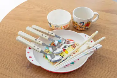a plate with chopsticks and utensils on a table at Tokyo Ikebukuro House in Tokyo