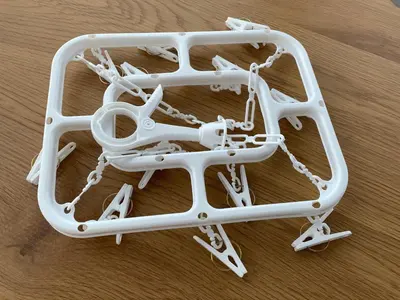 a pile of white plasticaments on a wooden table at Tokyo Ikebukuro House in Tokyo