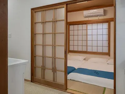 a room with a bed inside of a room at \u685c\u306e\u5ddd78 \u5317\u5343\u4f4f\u4e00\u6237\u5efa6-8\u4eba\u4e28Kita Senju villa for 6-8 people in Tokyo