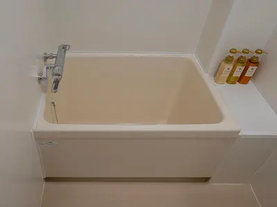 a white bath tub in a bathroom with two bottles at \u685c\u306e\u5ddd78 \u5317\u5343\u4f4f\u4e00\u6237\u5efa6-8\u4eba\u4e28Kita Senju villa for 6-8 people in Tokyo