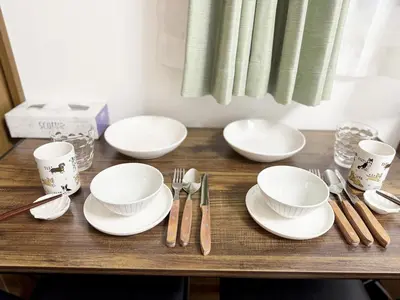 a table with white plates and utensils on it at 3-mins walk from Hibiya Line station in the Ueno area of Taito city, 2-bed private rental, 8 mins direct to Akihabara, 24 mins to Ginza in Tokyo
