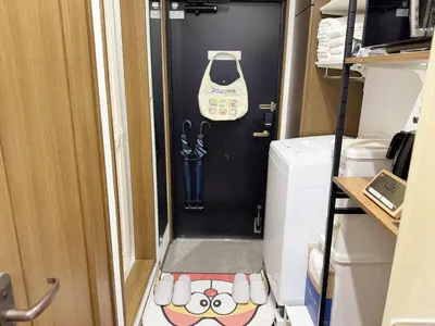 a hallway in an rv with a door to a washer at 3-mins walk from Hibiya Line station in the Ueno area of Taito city, 2-bed private rental, 8 mins direct to Akihabara, 24 mins to Ginza in Tokyo