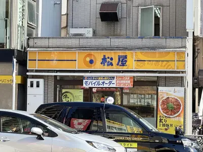 a street with cars parked in front of a building at 3-mins walk from Hibiya Line station in the Ueno area of Taito city, 2-bed private rental, 8 mins direct to Akihabara, 24 mins to Ginza in Tokyo