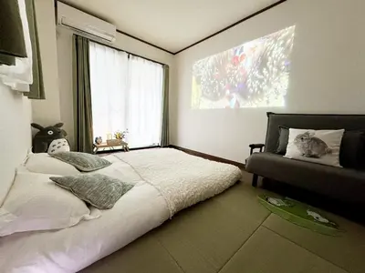 a bedroom with a large bed and a window at IITaito area,3 people,3-minute to station, 2-tatami beds,family type in Tokyo