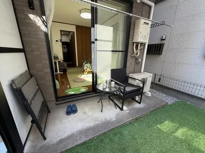 a small patio with a glass table and a chair at IITaito area,3 people,3-minute to station, 2-tatami beds,family type in Tokyo