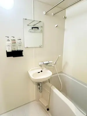 a white bathroom with a sink and a bath tub at IITaito area,3 people,3-minute to station, 2-tatami beds,family type in Tokyo