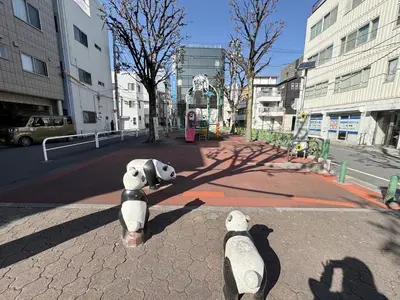 two stuffed teddy bears sitting on a city street at SIMMONS Brand beds,3 mins walk to station,,Ueno area,Direct to Akihabara 8 mins,Ginza 24 mins in Tokyo