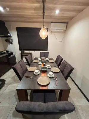 a dining room table with chairs and a projection screen at Luxury modern 3LDK in central Tokyo 5 min to Metro in Tokyo