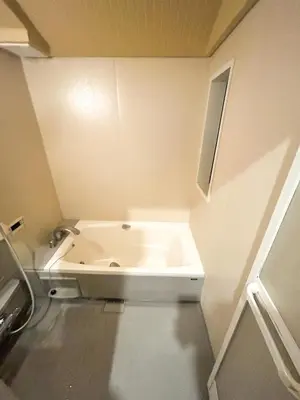 a small bathroom with a bath tub in the corner at Luxury modern 3LDK in central Tokyo 5 min to Metro in Tokyo