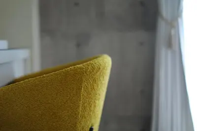 a yellow chair sitting next to a window at \u6771\u967d\u753a\u99c5\u5f92\u6b695\u5206 \u6700\u59275\u540d \u30d5\u30a1\u30df\u30ea\u30fc\u5411\u3051 \u6771\u4eac\u99c510\u5206 \u30c7\u30a3\u30ba\u30cb\u30fc \u30b9\u30ab\u30a4\u30c4\u30ea\u30fc\u4fbf\u5229 in Tokyo