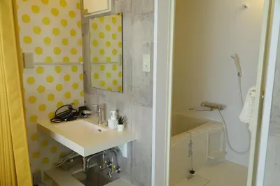 a bathroom with a sink and a mirror and a tub at \u6771\u967d\u753a\u99c5\u5f92\u6b695\u5206 \u6700\u59275\u540d \u30d5\u30a1\u30df\u30ea\u30fc\u5411\u3051 \u6771\u4eac\u99c510\u5206 \u30c7\u30a3\u30ba\u30cb\u30fc \u30b9\u30ab\u30a4\u30c4\u30ea\u30fc\u4fbf\u5229 in Tokyo