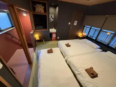 two beds in a room with two brown crosses on them at Yama Hotel Tsukiji in Tokyo