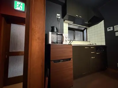 a small kitchen with a sink and a stove at Yama Hotel Tsukiji in Tokyo