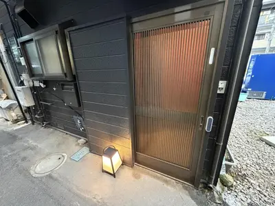 a door of a building with a light next to it at Yama Hotel Tsukiji in Tokyo