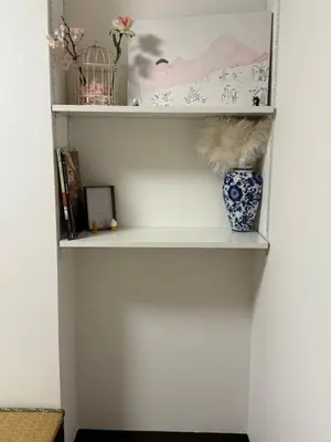a white shelf with a vase on it at Joyful inn in Tokyo