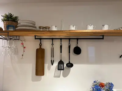 a shelf with utensils hanging on a wall at Joyful inn in Tokyo