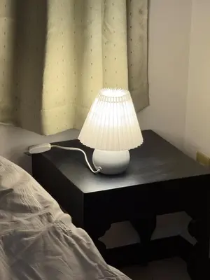 a lamp sitting on a table next to a bed at Joyful inn in Tokyo