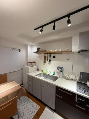 a large kitchen with a sink and a refrigerator at Joyful inn in Tokyo