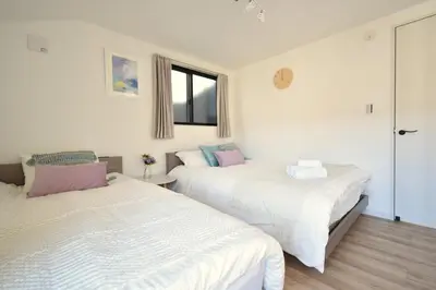 a bedroom with two beds and a window at 100sqm 4BDR New House! 6 minutes from Skytree by train in Tokyo