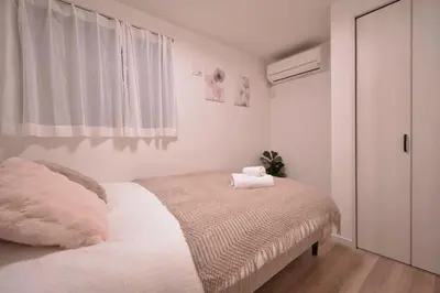 a white bedroom with a bed with a blanket at 100sqm 4BDR New House! 6 minutes from Skytree by train in Tokyo