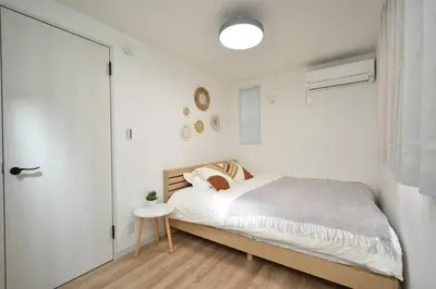 a white bedroom with a bed and a window at 100sqm 4BDR New House! 6 minutes from Skytree by train in Tokyo