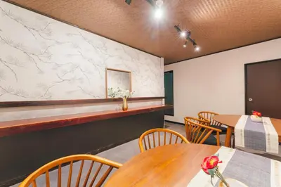 a restaurant with tables and chairs and a marble wall at 2BR Tokyo House easy Access to Asakusa 8ppl in Tokyo