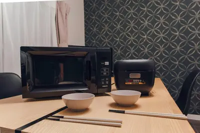 a microwave and two cups on a table at 2BR Tokyo House easy Access to Asakusa 8ppl in Tokyo