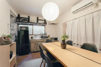 a kitchen with a table with chairs and a vase on it at 2BR Tokyo House easy Access to Asakusa 8ppl in Tokyo