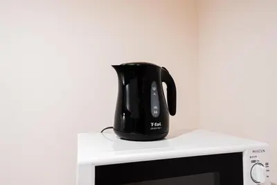 a black tea kettle sitting on top of a microwave at The Sky View Oshiage,Tokyo in Tokyo