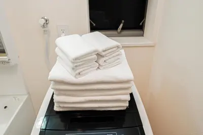 a stack of towels on a shelf in a bathroom at The Sky View Oshiage,Tokyo in Tokyo