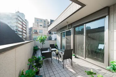 a balcony with chairs and tables on a building at The Sky View Oshiage,Tokyo in Tokyo