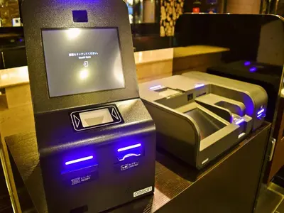 an atm machine sitting on top of a counter at APA Hotel Keisei Ueno Ekimae in Tokyo