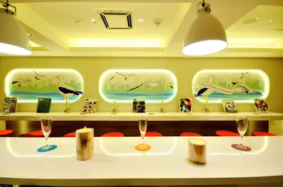 a room with two wine glasses on a table at Spa&Capsule Hotel Grandpark Inn Kitasenju in Tokyo