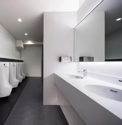 a bathroom with white sinks and a row of toilets at Tokyo Ariake Bay Hotel in Tokyo