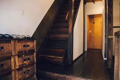 a wooden staircase in a room with a wooden dresser at hanare in Tokyo