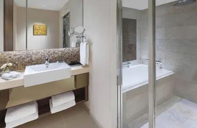 a bathroom with a sink and a tub and a shower at Oakwood Premier Tokyo in Tokyo