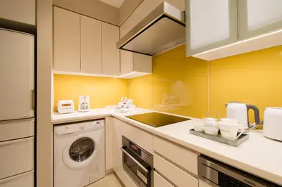 a kitchen with a washing machine and a washer at Oakwood Premier Tokyo in Tokyo