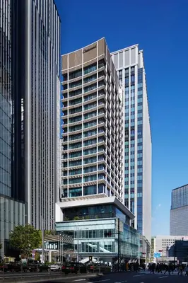a tall building with many windows in a city at Oakwood Premier Tokyo in Tokyo