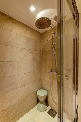 a bathroom with a toilet and a glass shower at Oakwood Premier Tokyo in Tokyo