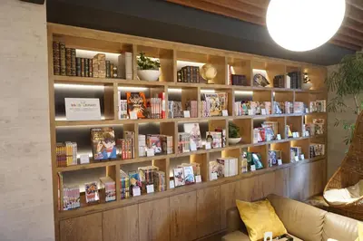 a book shelf filled with books in a room at MyCUBE by MYSTAYS Asakusa Kuramae in Tokyo