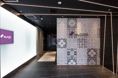 a room with a wall with a tile wall at MyCUBE by MYSTAYS Asakusa Kuramae in Tokyo