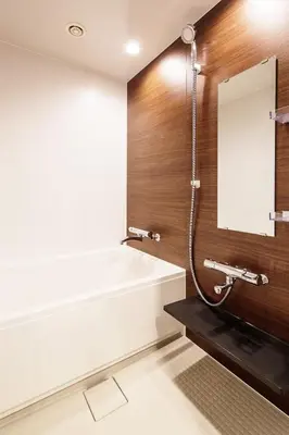 a bathroom with a bath tub and a mirror at MyCUBE by MYSTAYS Asakusa Kuramae in Tokyo