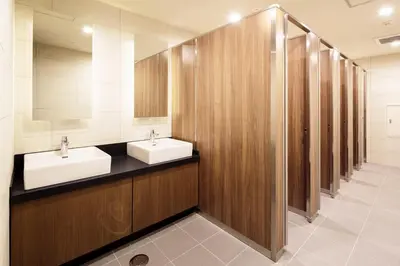 a bathroom with two sinks and stalls with mirrors at MyCUBE by MYSTAYS Asakusa Kuramae in Tokyo