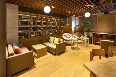 a restaurant with couches and chairs and a table at MyCUBE by MYSTAYS Asakusa Kuramae in Tokyo